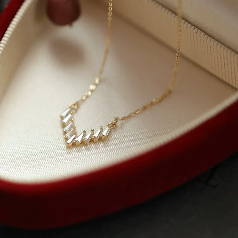 Wholesale 225 Silver Vshaped Women's Light Luxury Necklace With Small Skirt Pendant Inlaid With Square Zircon And Plated With 14K Gold And Chain With Letters Numbers Text Pattern
