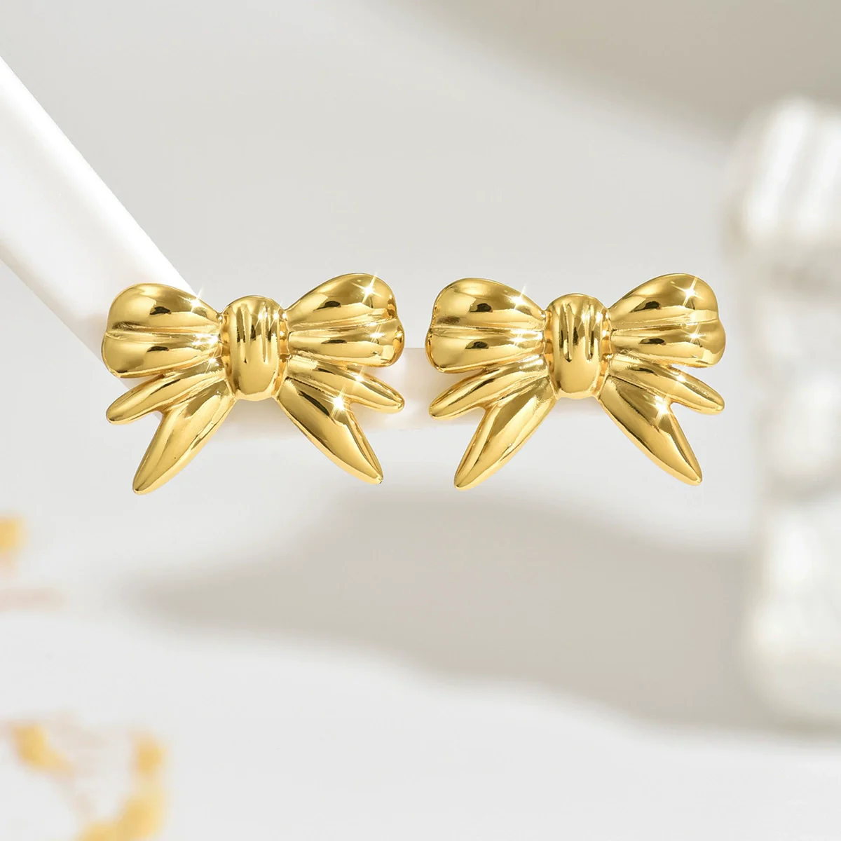 Wholesale Women's Stainless Steel Stamped Bow Tie Earrings With Hydraulic Design
